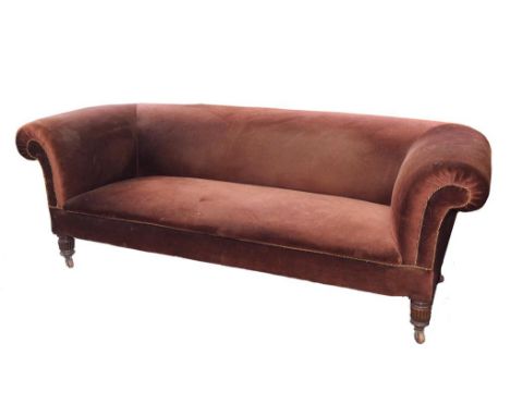 A VICTORIAN CHESTERFIELD SOFA ON REEDED MAHOGANY LEGS WITH POTTERY CASTORS 