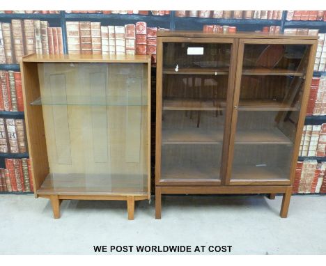 Two glazed display/bookcases, one with ministry broad arrow to rear.