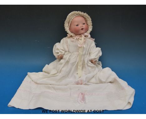 An Armand Marseille bisque headed doll with open mouth and weighted brown eyes, marked to back of neck AM Germany 351/3 1/2 K