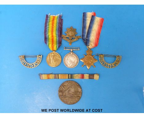 WWI medal trio awarded to 10-15645 Pte W Howell Worcestershire Regt together with a Lusitania medal, shoulder titles etc.