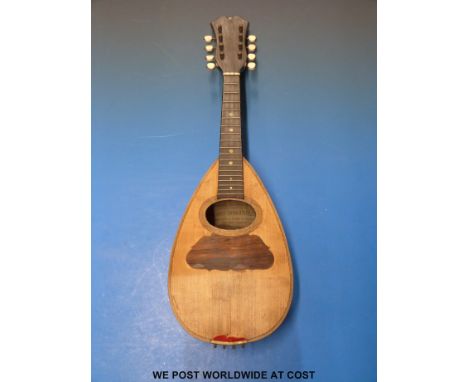 A mandolin by G Grandini with inlaid rosewood back, bone tuning pegs and mother-of-pearl inlay in original case