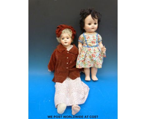 An unmarked bisque headed doll with open mouth and fixed brown eyes. Dressed in velvet coat with enamel buttons and matching 