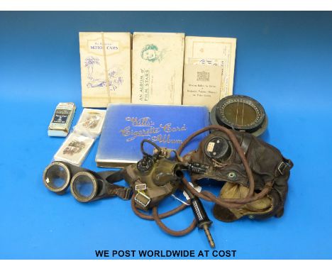 A Type 8 Spitfire compass together with a pilot's helmet and goggles and a collection of inter-war cigarette cards to include