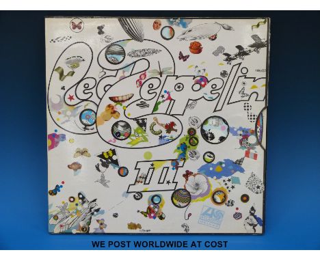 “Led Zeppelin III”.  Contains two vinyl records in a gatefold rotating wheel sleeve both with red/maroon labels on Atlantic D
