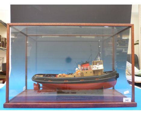 A 1:48 scale model tug boat in glass case.