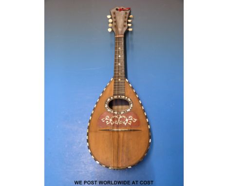 A cased mandolin by Luigi Poppi Palmero decorated with tortoiseshell and mother of pearl inlay.
