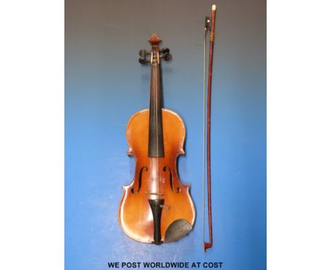 A 20thC cased anonymous violin with 33.5cm flame back, complete with bow and case.