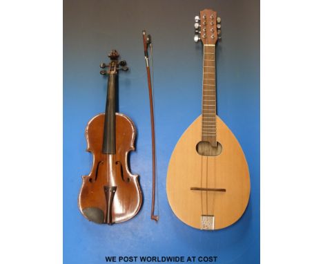 A late 20thC flat-backed mandolin together with a vintage anonymous violin with 35.5cm back and bow in case.