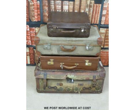 Four vintage leather and canvas suitcases, some with original shipping labels.