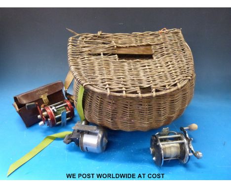 Vintage wicker fishing creel with Abu & Penn multipliers and an Abu closed faced reel.