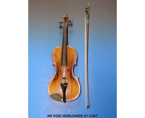 A late 19th/early 20thC Stradivarius copy violin with 36cm back and bow in case. 