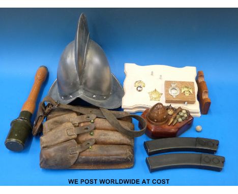 A quantity of militaria to include magazine pouch, replica stick grenade, replica helmet, mounted militaria displays etc