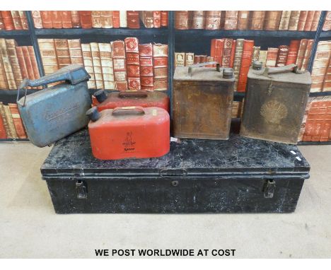 A metal trunk with vintage petrol cans 