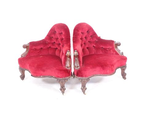 A pair of Victorian button-back upholstered corner armchairs, on scrolled cabriole legs 