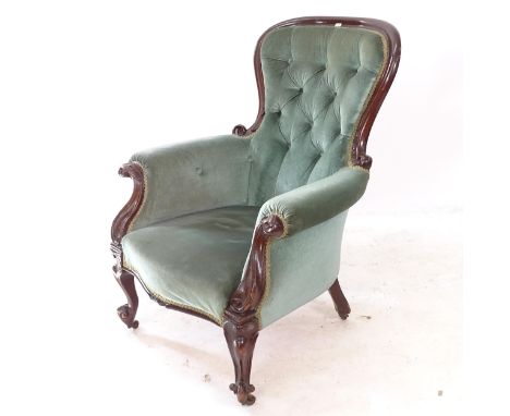 A Victorian mahogany-framed and button-back rollover armchair, on cabriole legs 