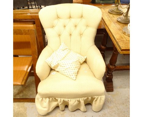 An Edwardian button-back upholstered armchair 