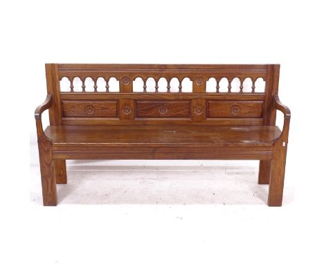 A 19th century oak hall bench, with a spindle and carved panelled raised back, L160cm, H90cm, D38cm, seat depth 36cm 