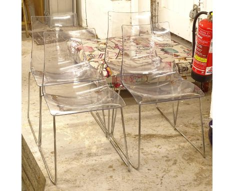 A set of 4 contemporary design dining chairs, with clear moulded plastic seats, on tubular chromed sled bases 
