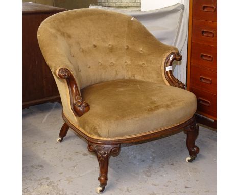 A Victorian button upholstered and carved walnut-framed bow-arm chair 