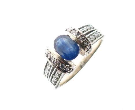 Sapphire and diamond dress ring, the white metal shank stamped '14K', the oval cut sapphire 7mm x 5mm approx, size P approx, 