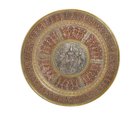 Indian brass and copper charger of circular form, decorated in relief with panels of figures, the central panel silvered, 56.