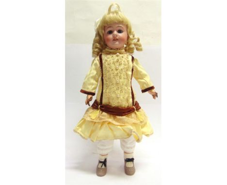 A BISQUE SOCKET HEAD DOLL  with a replacement curled blonde wig, sleeping blue glass eyes, pierced ears and an open mouth wit