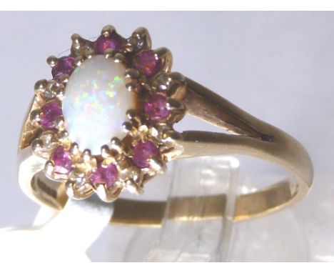 9 CT RUBY, DIAMOND AND OPAL RING. 9 ct gold ruby, diamond and opal ring, size T