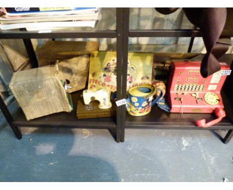 VINTAGE TOYS. Shelf of vintage toys including sewing machine and typewriter