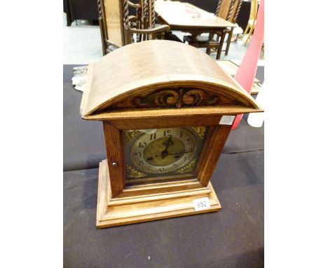 OAK MANTEL CLOCK. Oak cased mantel clock with silver gilt dial