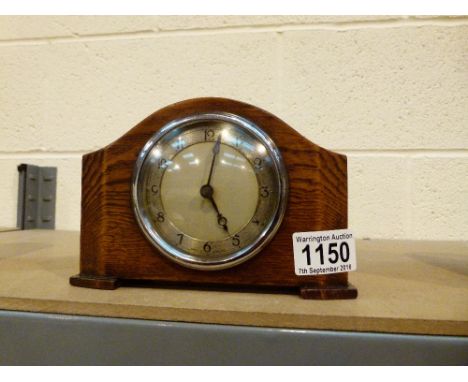 OAK CASED MANTEL CLOCK. Small mechanical oak cased mantel clock