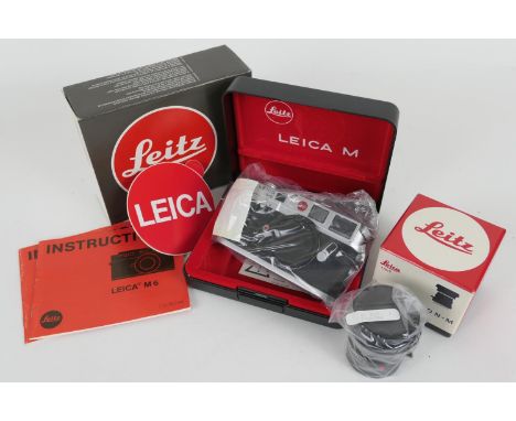 Leica M6 35mm camera (10414), in original sealed clear plastic bag, apparently unused, in original hard plastic case with out