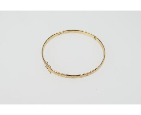 Modern 9ct gold hinged bangle, foliate engraved decoration, cuff size 62mm, gross weight approx. 19.1g 