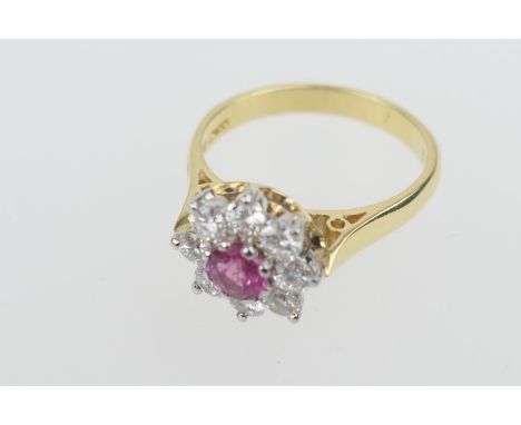 Diamond and ruby cluster ring, the central round cut ruby of approx. 0.5ct, bordered with eight round brilliant cut diamonds 