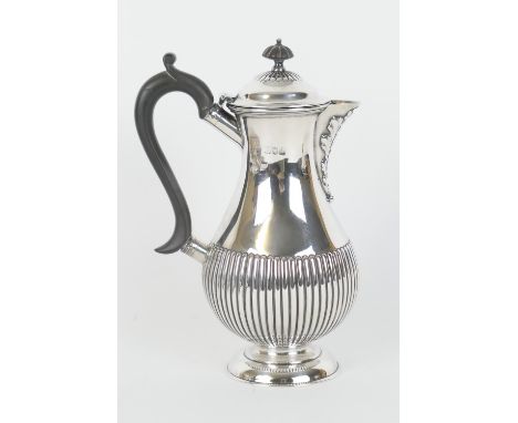 Late Victorian  silver baluster hot water jug, by William Hutton &amp; Sons, London 1896, half reeded and with ebony handle a