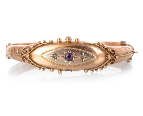 AMETHYST AND DIAMOND BANGLE, set with central amethyst flanked by diamond chips, with beadwork decoration, in nine carat rose