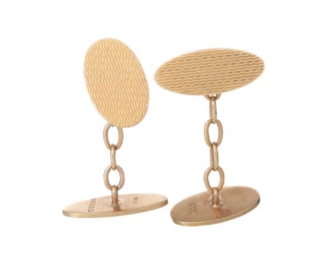 PAIR OF NINE CARAT GOLD OVAL CUFFLINKS,  each panel with engine turned decorationQty: 10g