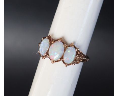A 9ct yellow gold three stone opal ring, size O, approximately 4 grams