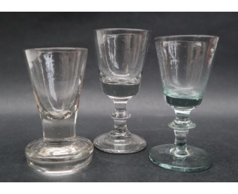 A 19th century toast masters glass with a tapering bowl and integral column on a thick spreading foot, 9.5cm high together wi