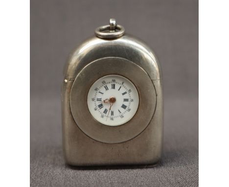 A continental white metal travel clock vesta case, of domed form with a ring top, the enamel dial with Roman numerals, 5cm hi