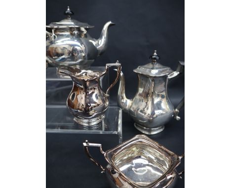 An Edward VII four piece silver tea set, of square form, comprising hot water jug, teapot, cream jug and sugar basin, London,