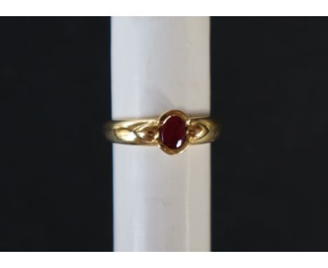 An 18ct yellow gold ring set with an oval faceted ruby, size M 1/2, approximately 2.7 grams