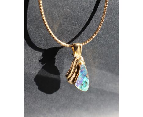 An 18ct yellow gold pendant set with a Queensland boulder opal with three brilliant Cut diamonds on an 18ct gold chain, appro