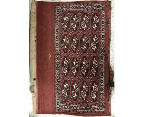 A vintage Juval rug, the main panel set with four rows of repeating medallions on a dark red ground within a stepped geometri