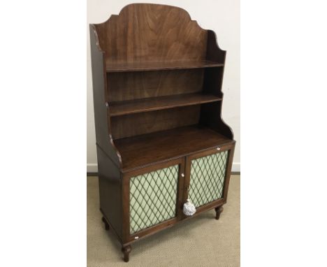 A 19th Century mahogany side cabinet, the three quarter galleried top with two shelves, over two brass lattice work and fabri