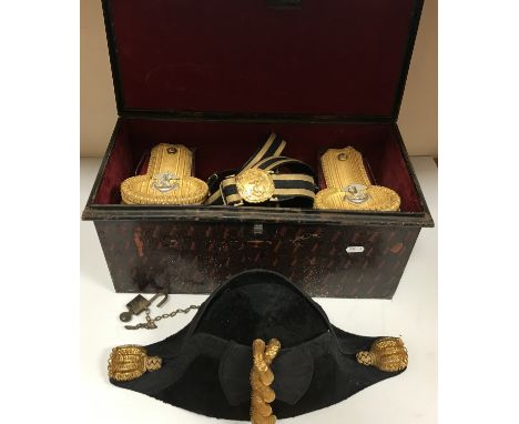 A British Royal Naval officer's bicorn hat, epaulettes and belt and sword sling by Gieves Ltd, stamped "By special appointmen