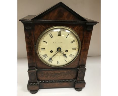 An early 19th Century mahogany cased mantel clock of architectural form, the eight day movement with circular painted dial in