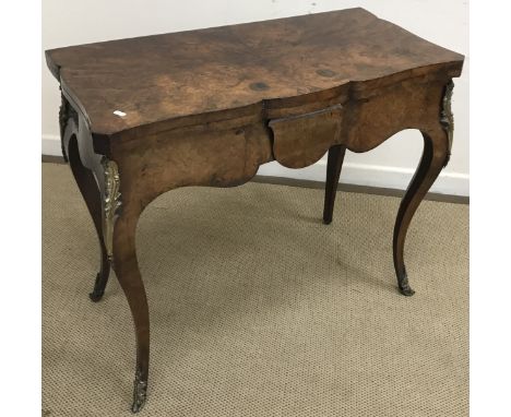 A 19th Century French burr walnut fold-over card table, the shaped top opening to reveal a baize-lined interior over a shaped