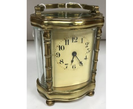 A circa 1900 French brass cased carriage clock/time piece of ogee form, the movement by Richard & Co of Paris with white/crea