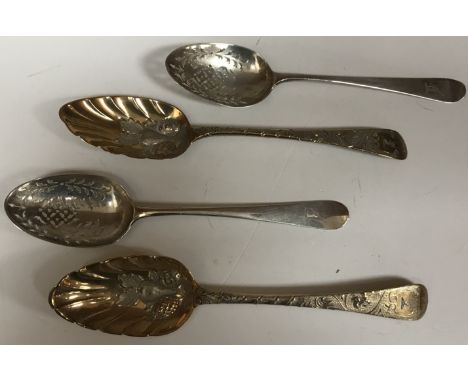 A pair of George III silver gilt fruit spoons, the shell shaped bowls with later embossed fruit decoration and engraved scrol