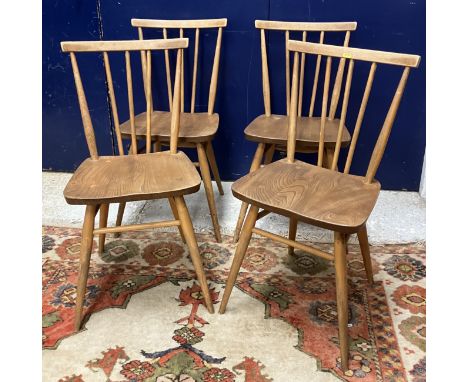 A set of four Ercol 'Windsor 391' stick back kitchen dining chairs with shaped seats on turned tapering splayed supports unit